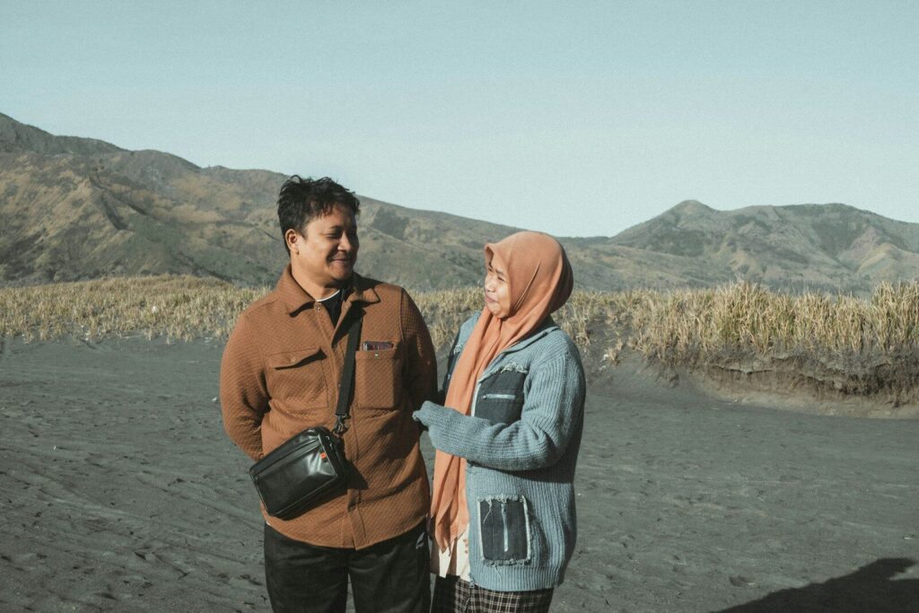 A man and a woman standing on a beach
