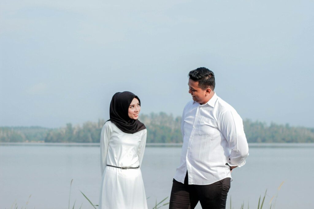 couple standing beside sea