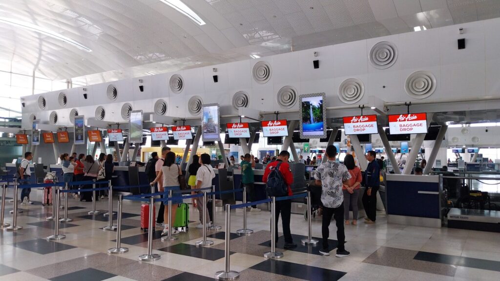 A group of people waiting in line at an airport