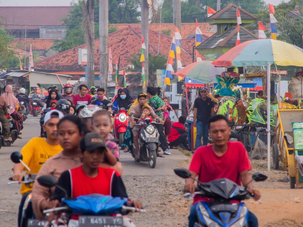 people sitting on red and black motorcycle during daytime