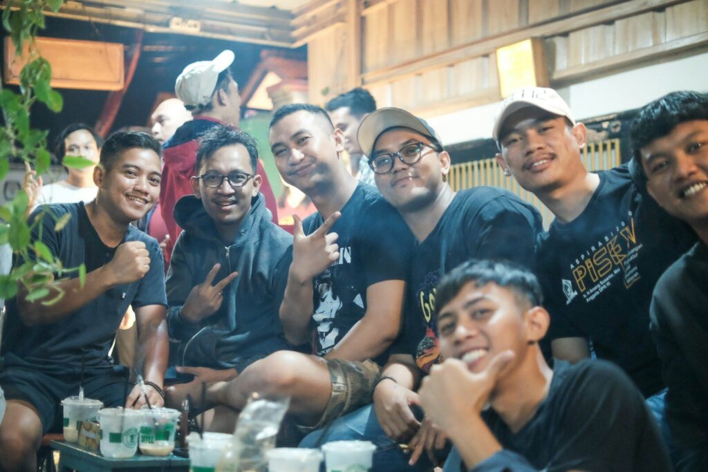 a group of young men sitting next to each other