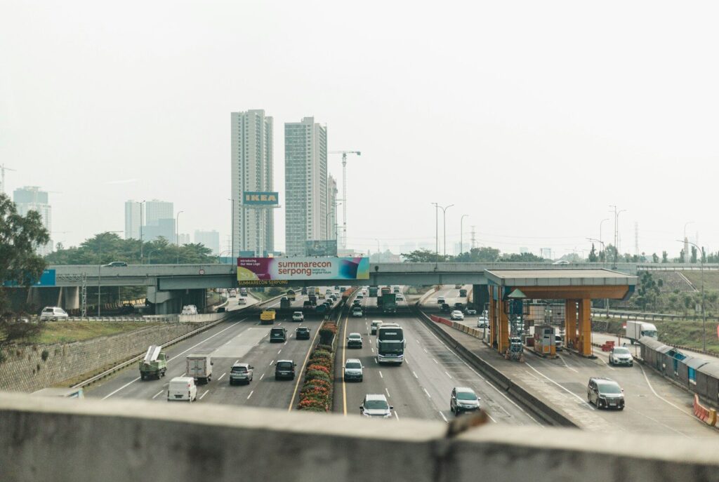 Cars driving through a toll plaza on a highway.