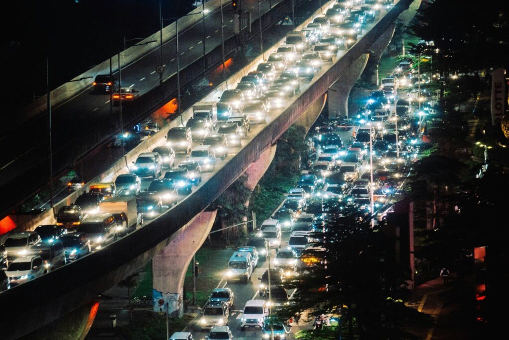 a long line of cars on a highway at night