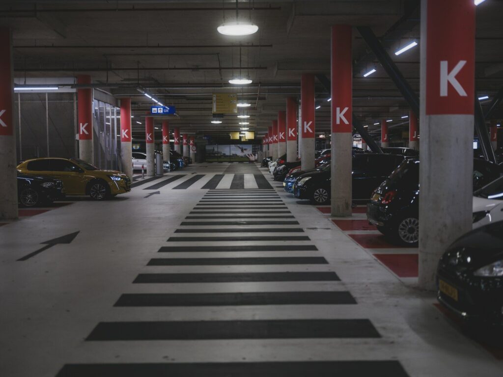 Cars parked in a dimly lit underground parking garage.