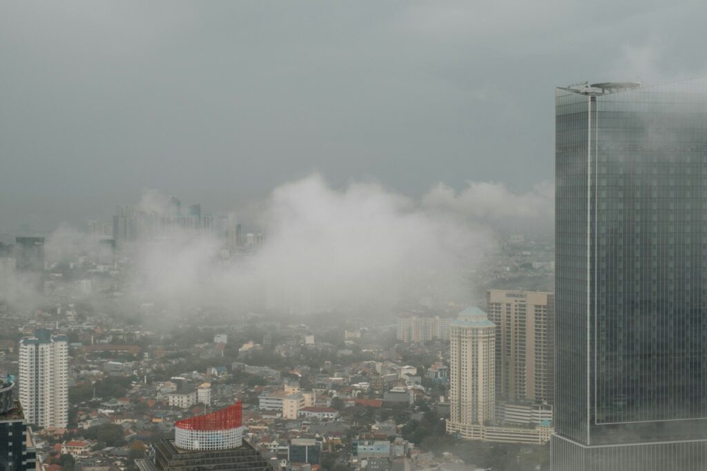 a city with a lot of tall buildings in the fog